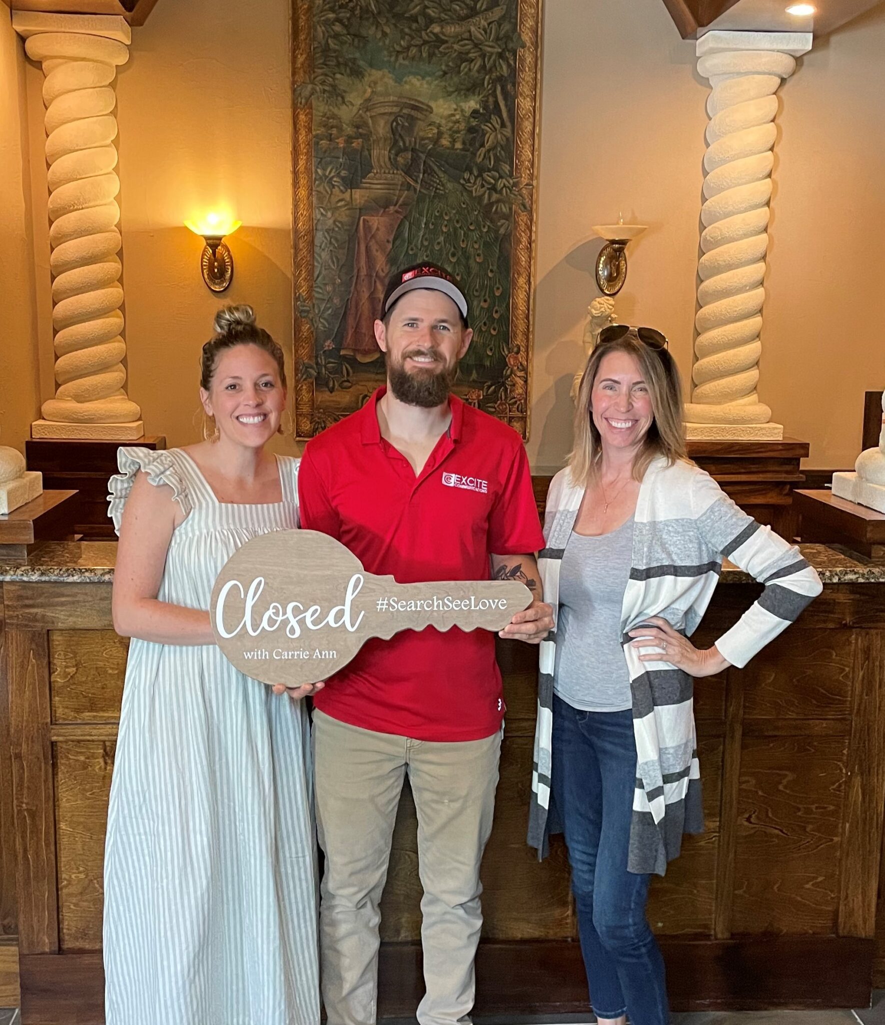 Michael & Jessica holding their closed sign for their new home.