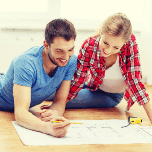 couple reviewing home floorplan debate space needs